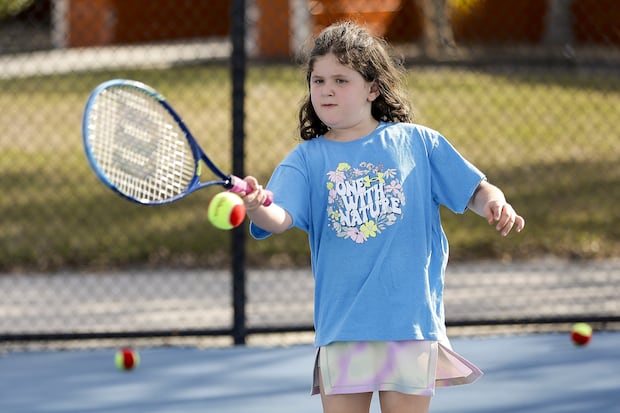 Abby Silver, 7 hits a tennis ball as part of the Little Hawks tennis class at the Hillsborough College Tennis Center on March 4 in Tampa. 