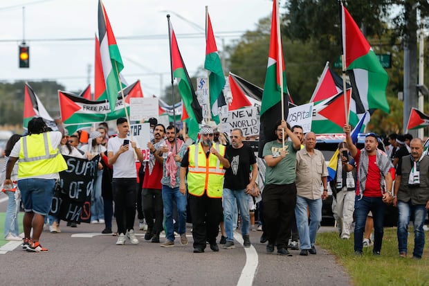 Hatem Naji Fariz, center, leads a march along Fowler Avenue in support of the Palestinian people on Oct. 25, 2023, in Tampa.