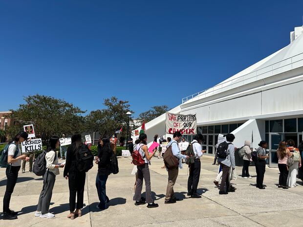 Protesters at the University of Florida outside a career fair in September.