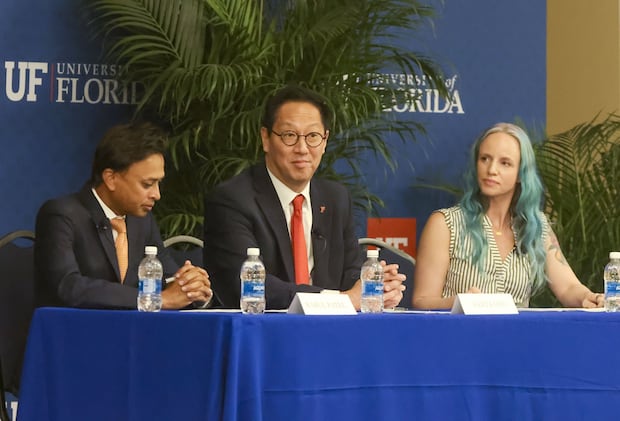 Santa Ono, center, is flanked by Rahul Patel, left, and Sarah Lynne while attending a faculty forum at the University of Florida on Tuesday.